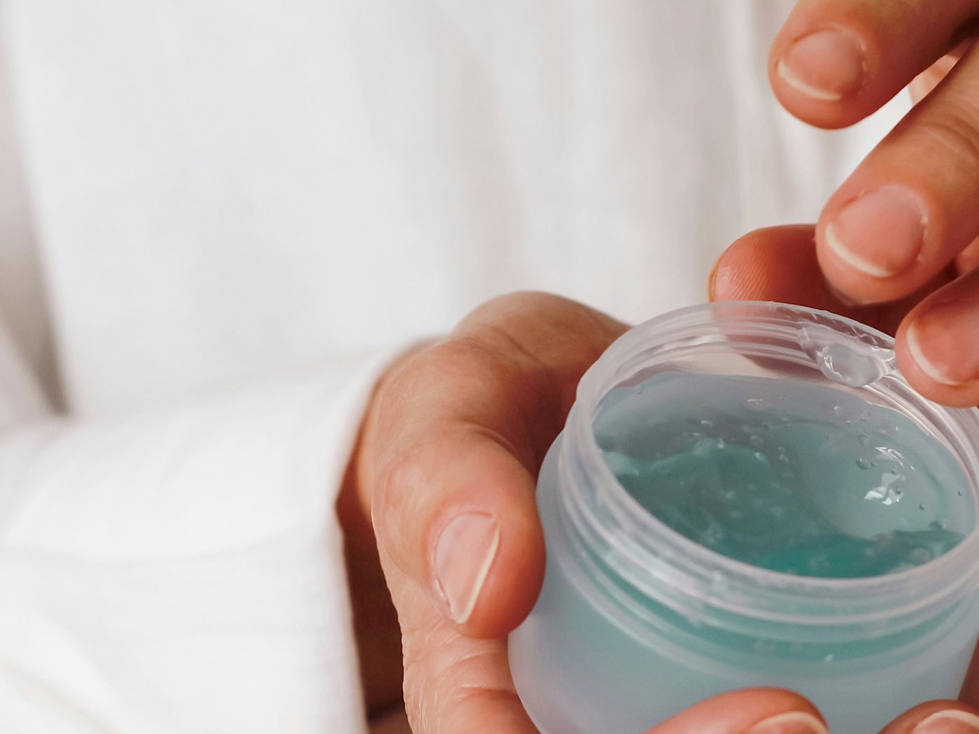 Holding an open beauty product jar